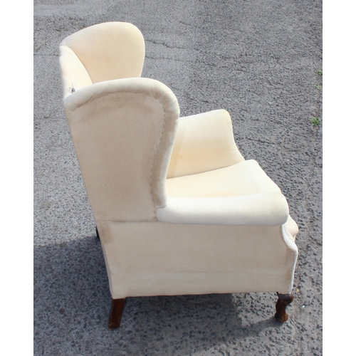 88 - An antique wingback armchair with sprung seat, ready for upholstery