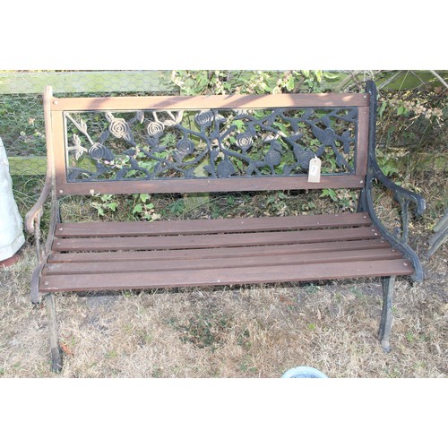 389 - Wooden slatted garden bench with metal ends and floral back