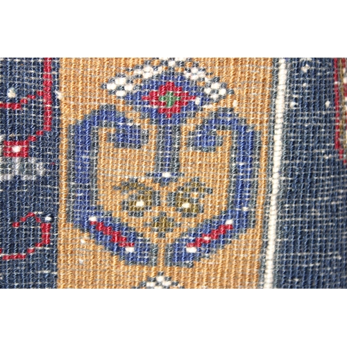 214 - A vintage hand knotted rug of blue ground with large red medallion and decorative cream border, appr... 