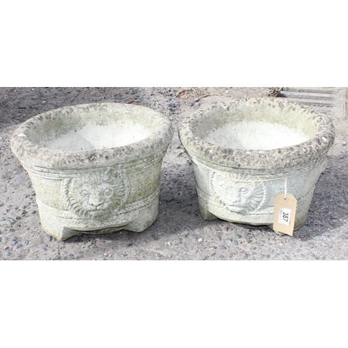 387 - A pair of concrete garden pots with lion masks