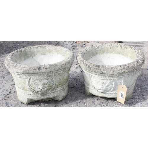 387 - A pair of concrete garden pots with lion masks