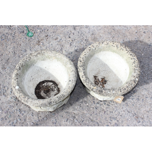 387 - A pair of concrete garden pots with lion masks