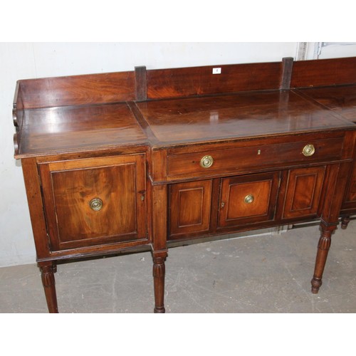 146 - An early 19th century mahogany breakfront sideboard, the galleried top above central drawer with cup... 