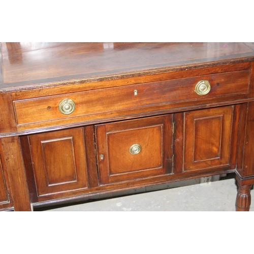 146 - An early 19th century mahogany breakfront sideboard, the galleried top above central drawer with cup... 