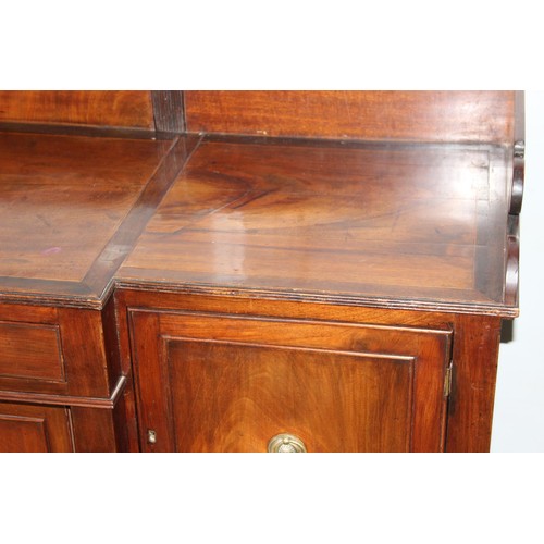 146 - An early 19th century mahogany breakfront sideboard, the galleried top above central drawer with cup... 