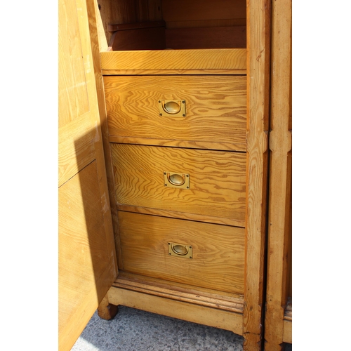 1 - A large vintage pine wardrobe with gothic style strapwork hinges, the interior containing shelves an... 