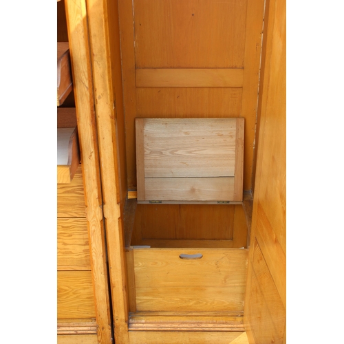 1 - A large vintage pine wardrobe with gothic style strapwork hinges, the interior containing shelves an... 