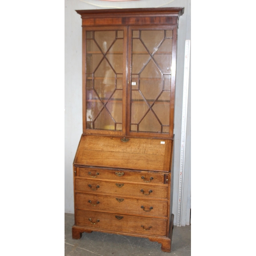 41 - A Georgian oak Bureau bookcase with astrral glazed top and brass drop handles