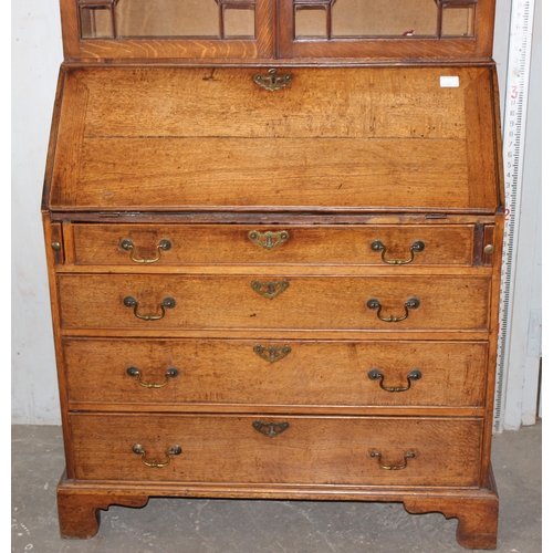 41 - A Georgian oak Bureau bookcase with astrral glazed top and brass drop handles