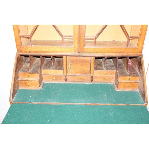 41 - A Georgian oak Bureau bookcase with astrral glazed top and brass drop handles