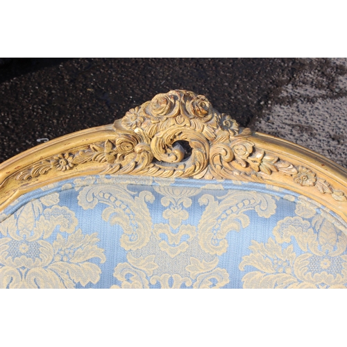 100 - A pair of French style high backed armchairs with carved giltwood frame and blue & gold upholstery, ... 