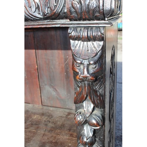 102 - An antique carved dark oak bookcase in the Jacobean style, approx 110cm tall x 94cm wide