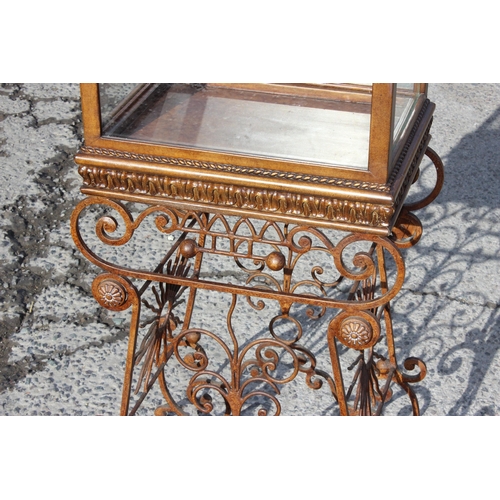 107 - An antique style glazed bijouterie or display cabinet on wrought iron stand