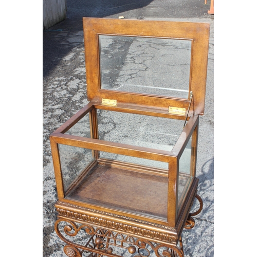 107 - An antique style glazed bijouterie or display cabinet on wrought iron stand