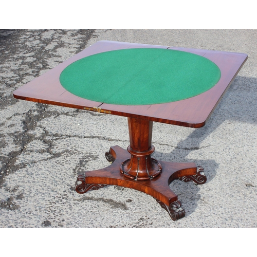 108 - A 19th century mahogany fold over card table with pedestal support