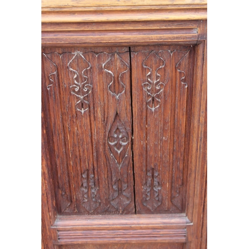 82 - An unusual antique oak chapel seat or high backed single pew with linen fold end panels, approx 130c... 