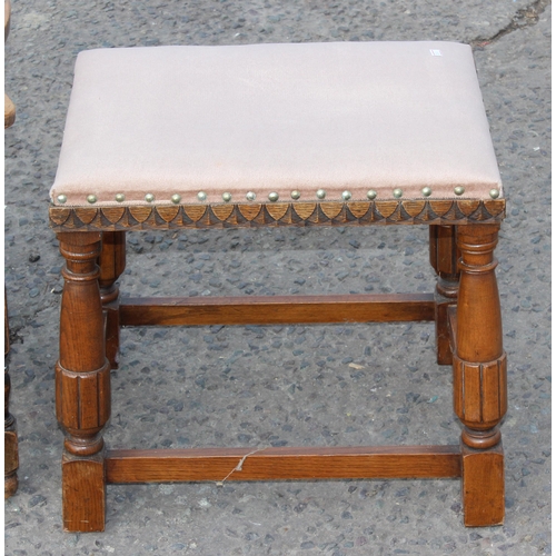 88 - A vintage low oak armchair with matching stool with carved details (2)