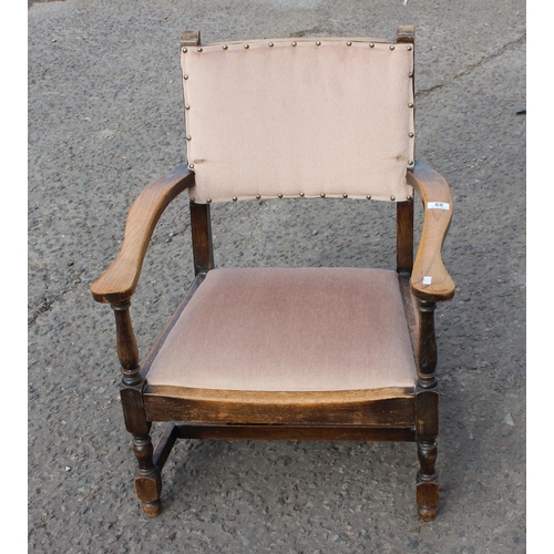 88 - A vintage low oak armchair with matching stool with carved details (2)