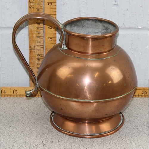 1712 - A vintage copper jug with brass armorial crest