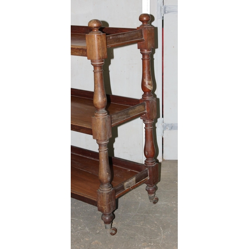 119 - A Victorian mahogany 3 tier buffet stand or dumb waiter, with carved dome shaped finials and raised ... 