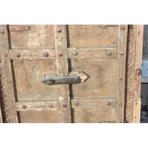 227 - A rustic wooden window shutter with iron fittings and carved details