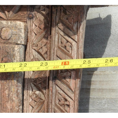 227 - A rustic wooden window shutter with iron fittings and carved details