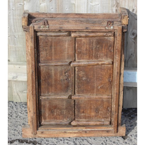 227 - A rustic wooden window shutter with iron fittings and carved details