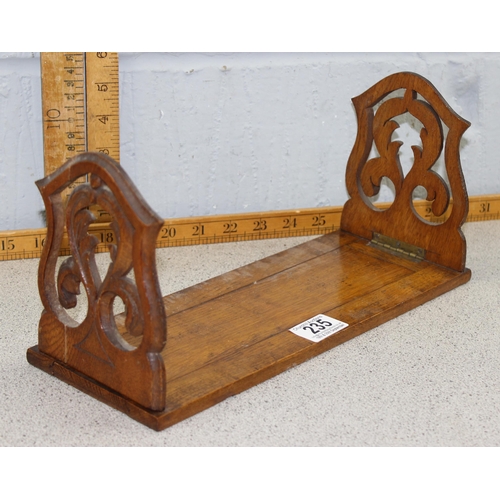 235 - A gothic style carved oak bookslide and a treen lidded pot (2)