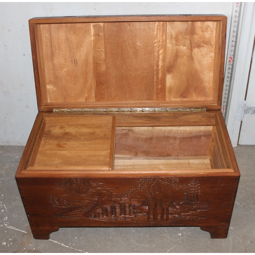 125 - A vintage carved camphor wood chest decorated with Oriental scenes