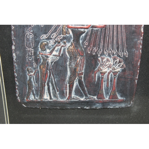 334 - A large bronzed Egyptian style plaque depicting sun worshiping, in ebonised carved wooden frame