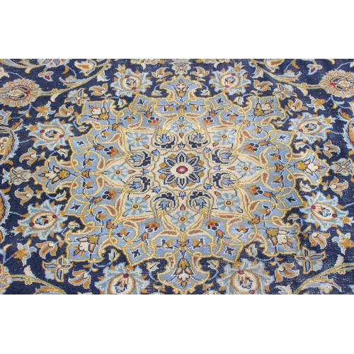 167 - A large Iranian hand knotted rug of blue ground with various decorative arabesque motifs, approx 410... 