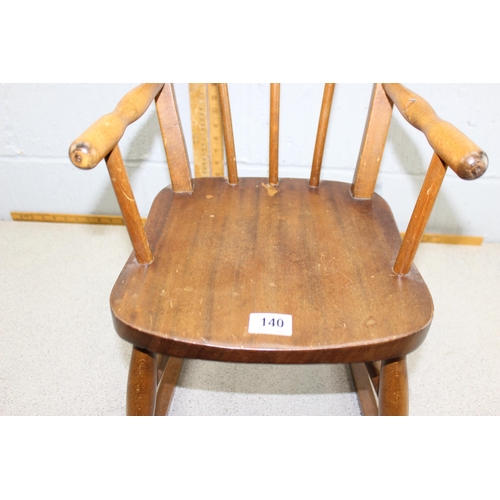 140 - A vintage Ercol style child's wooden rocking chair