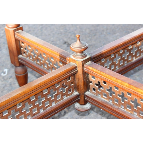 142 - A late Victorian mahogany octagonal table standing on brass and ceramic castors with Aesthetic Movem... 