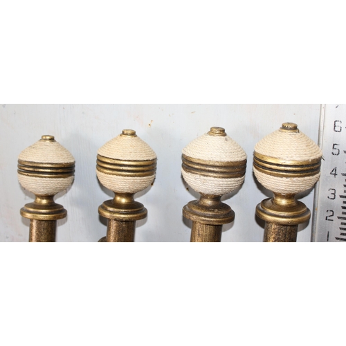 164 - Four designer gilded wooden curtain poles with matching fixing brackets,
curtain rings and wrapped s... 