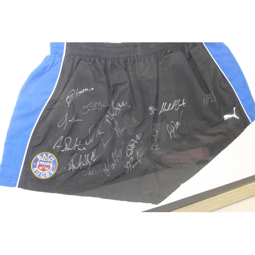 348 - Framed and mounted Bath Rugby club puma shorts with team signatures with Superstars label to reverse