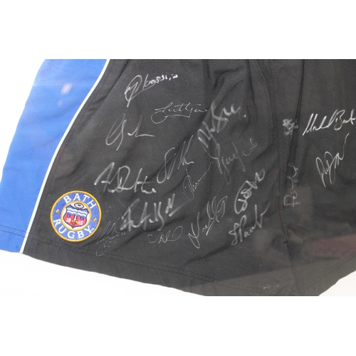 348 - Framed and mounted Bath Rugby club puma shorts with team signatures with Superstars label to reverse