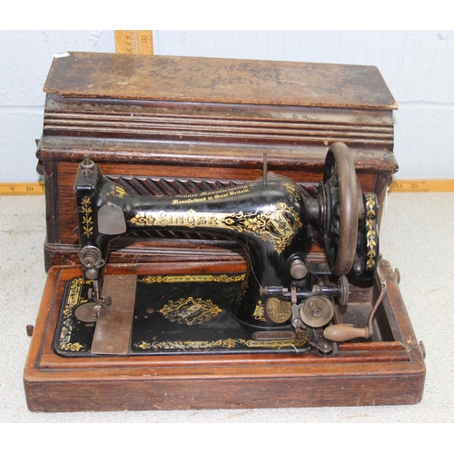 945 - Antique cast iron sewing machine in wooden case