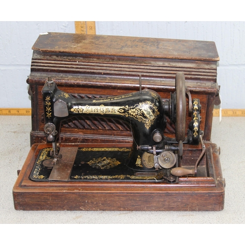 945 - Antique cast iron sewing machine in wooden case