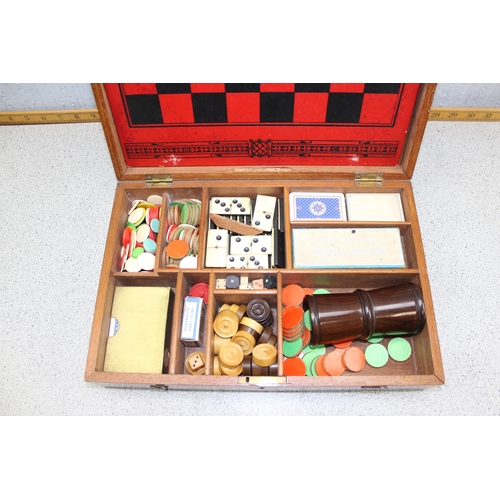 1533 - An antique wooden cased games compendium with Moroccan leather games board, various vintage and late... 