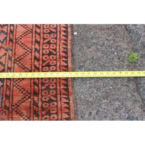 154 - A large red ground Afghan rug decorated with gul, approx 310cm x 220cm