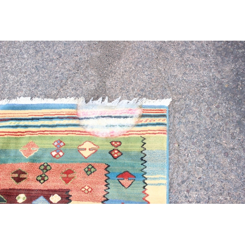 155 - A colourful decorative modern rug, approx 240cm x 165cm