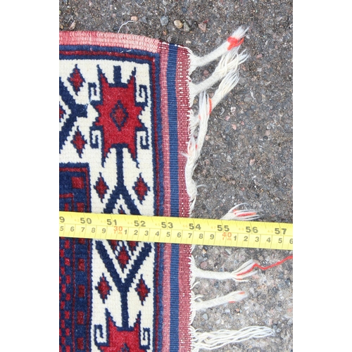 165 - A small Turkish Yagcibedir handmade rug of blue and red ground, made in the West Anatolia region, ap... 