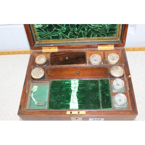 249 - An antique mahogany travelling vanity box, with fitted interior, containing cut glass and silver pla... 