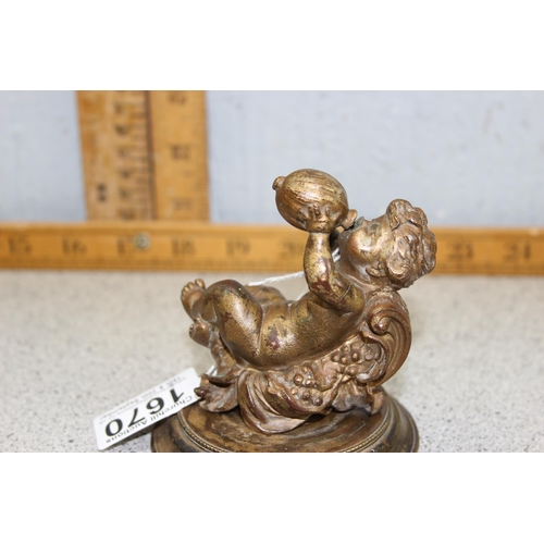 1670 - An antique cast bronze paper or desk weight formed as a Bacchanalian cherub drinking from a gourd, l... 