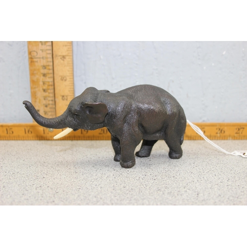 1672 - A cast bronze figure of an elephant, likely 20th century, approx 16cm long, unmarked