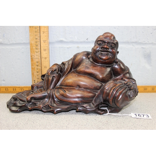 1673 - An Oriental carved hardwood figure of a recumbent Buddha, likely early 20th century, approx 32cm wid... 