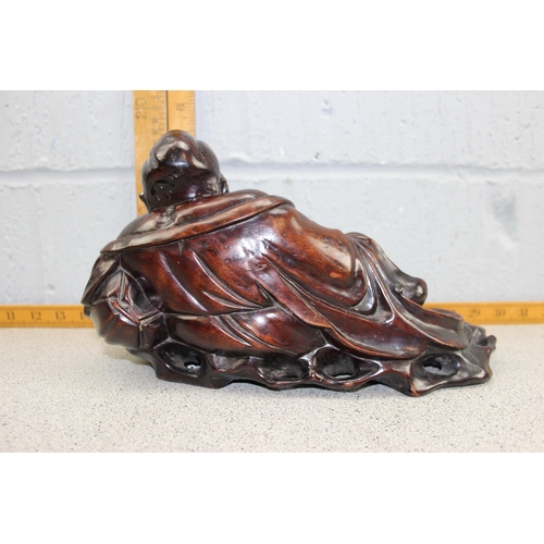 1673 - An Oriental carved hardwood figure of a recumbent Buddha, likely early 20th century, approx 32cm wid... 