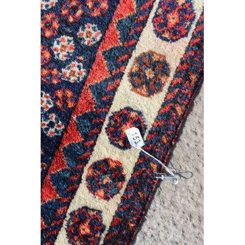 153 - A vintage red and blue ground hand made rug with 3 diamond medallions, approx 240cm 130cm