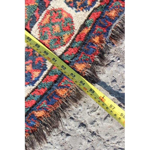 153 - A vintage red and blue ground hand made rug with 3 diamond medallions, approx 240cm 130cm