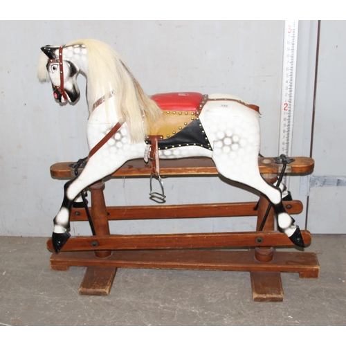 120 - A small late 19th century English carved wooden rocking horse on trestle rocker, with open mouth wit... 